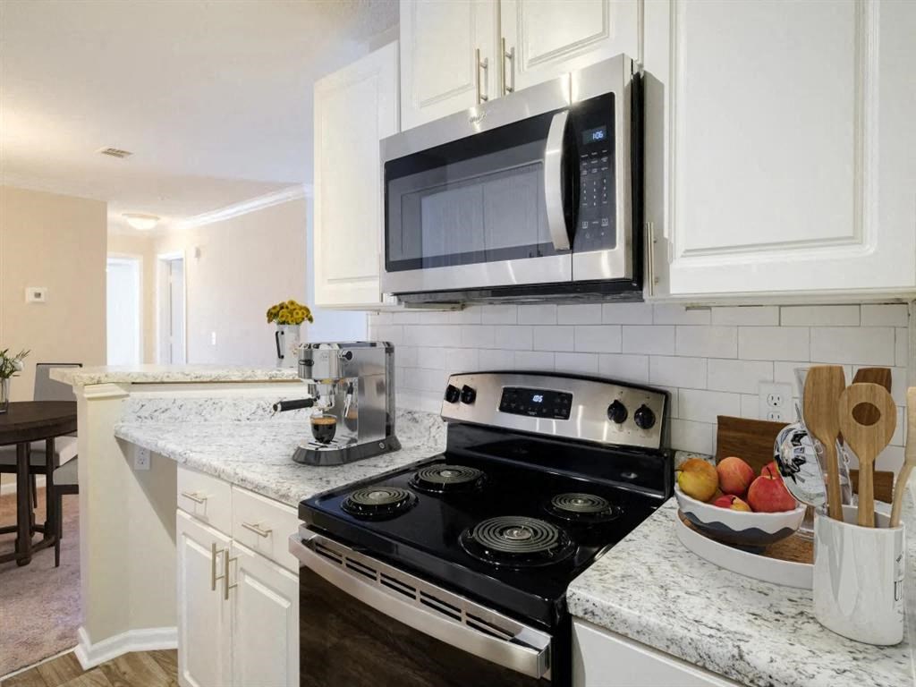 a kitchen with a stove and a microwave
