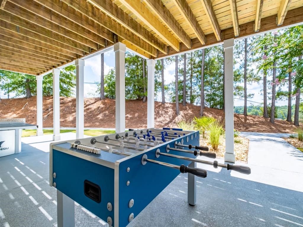 a foosball table in the shade of a pavilion
