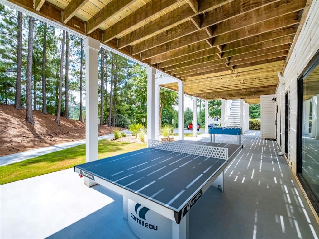 a ping pong table on the porch of a house