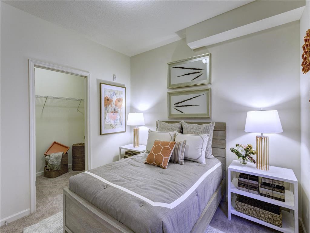 a bedroom with a large bed and a mirror