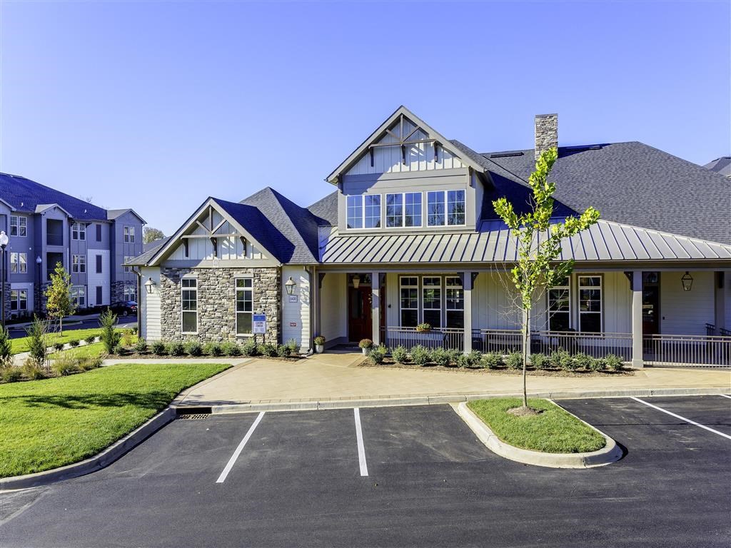 a large house with a parking lot in front of it