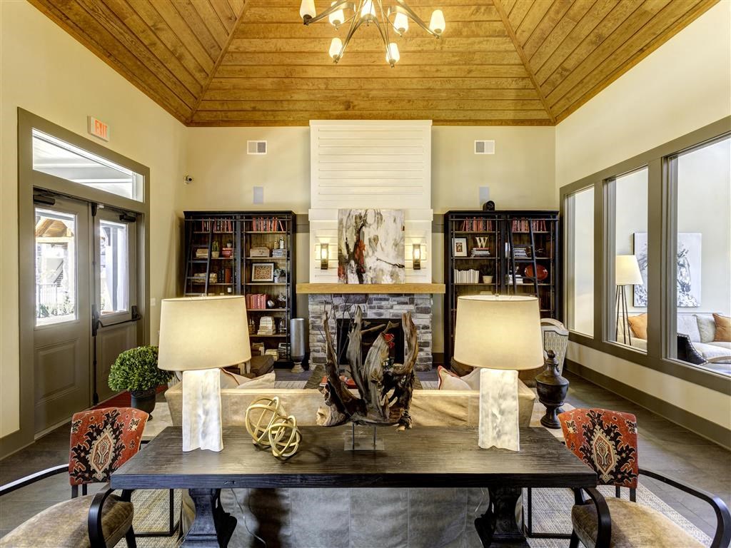a living room with a table and a fireplace