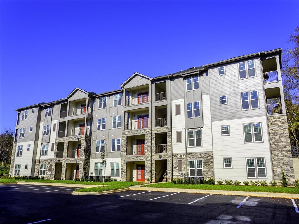an apartment building with an empty parking lot