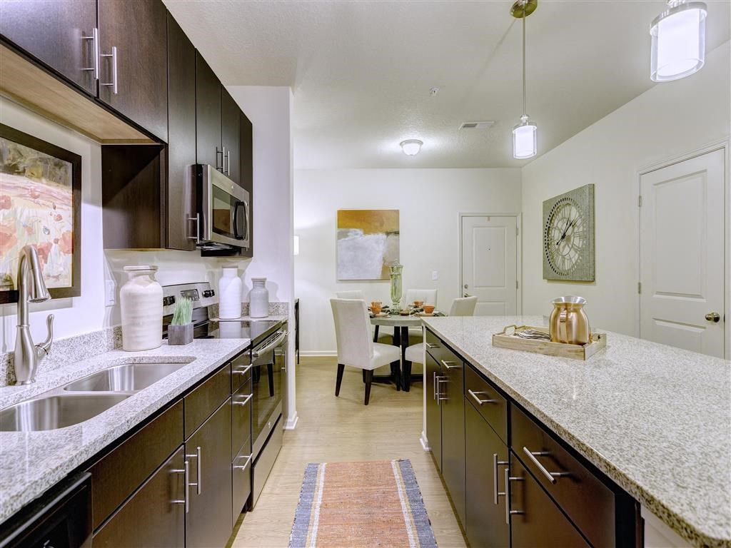 New Apartments in Louisville KY - SpringHouse - Kitchen With an Oven, Microwave, Sleek Counters, and a View of the Dining Room