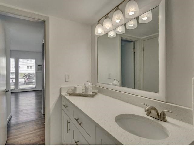 a bathroom with two sinks and a large mirror
