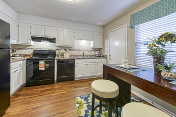 kitchen with wood-style floors and white cabinets at Ascent Jones Apartments in Huntsville, Alabama Kitchen with backsplash at Ascent Jones Apartments in Huntsville, Alabama