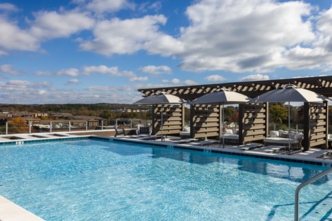 Rooftop pool area with modern cabanas and pergola at 2020 Providence Apartments, Huntsville, Alabama