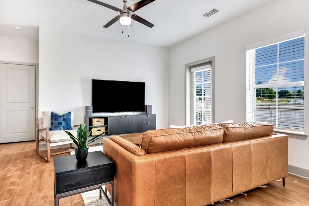 modern and open concept living room with wood floors at Anthem Apartments and Cottages in Huntsville, Alabama