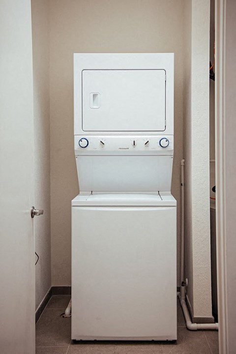 a white washer and dryer in a closet