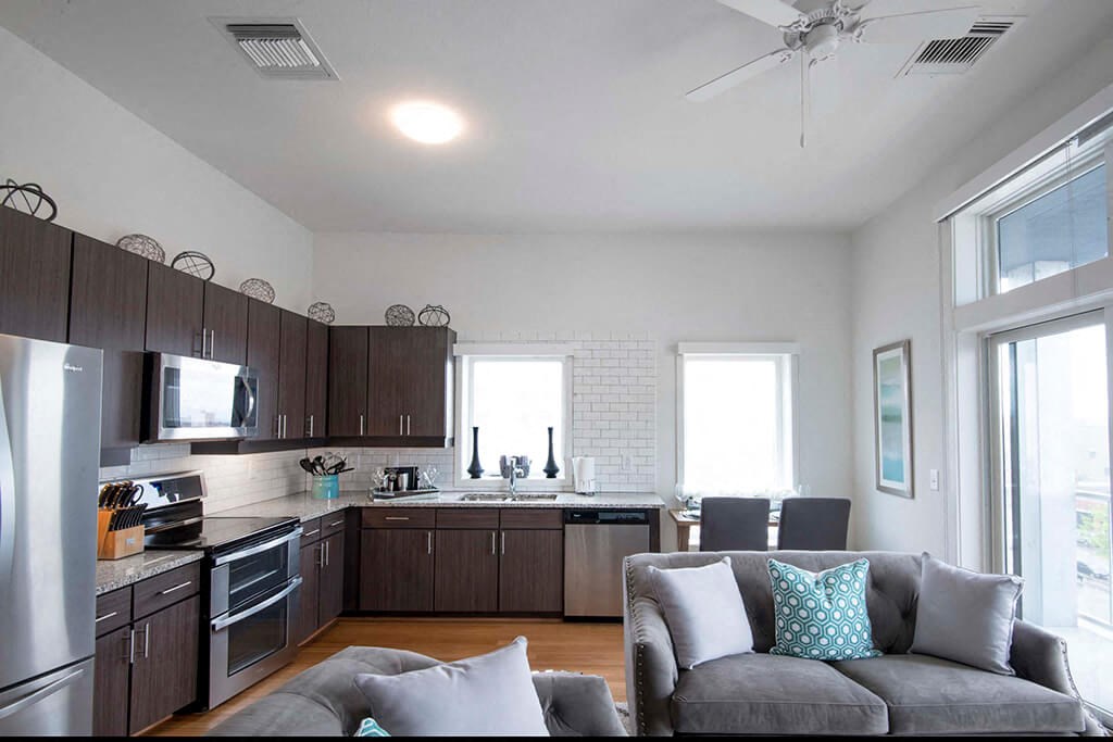 an open kitchen and living room with a couch