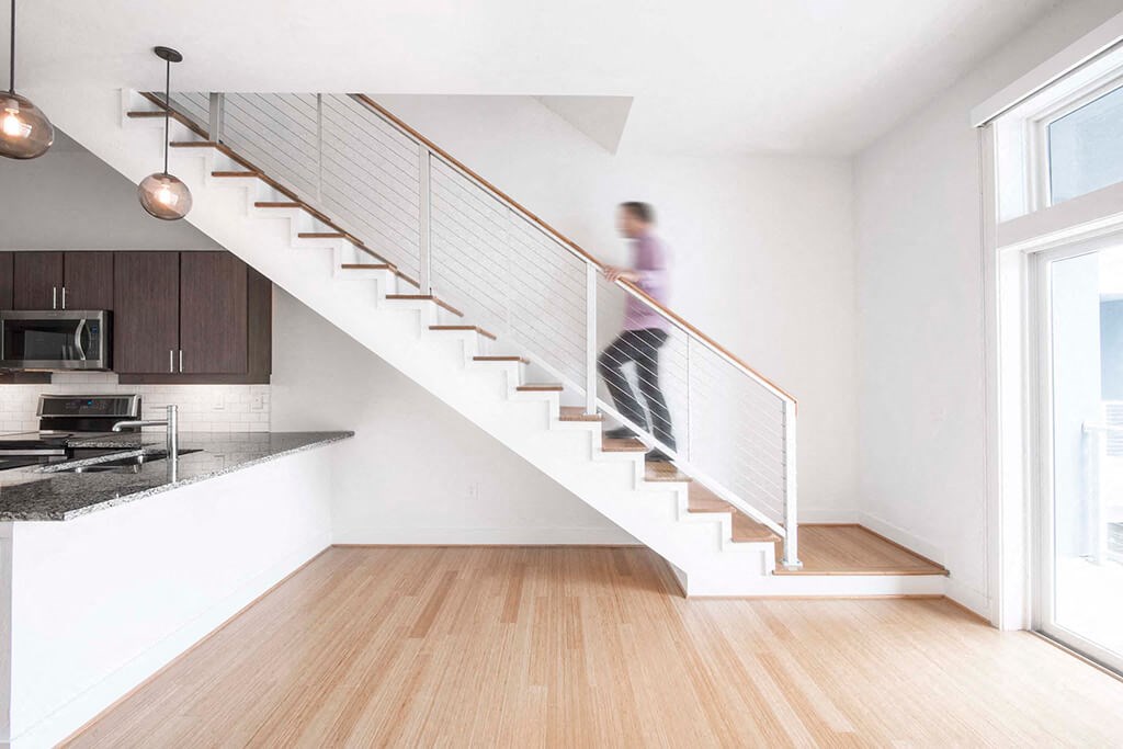 a man walking down a staircase in a home