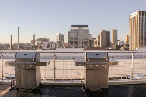 the city skyline is seen from the roof of a building with two generators on it