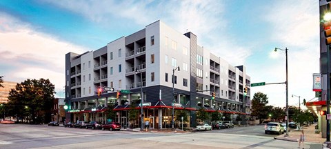 an apartment building on the corner of a city street