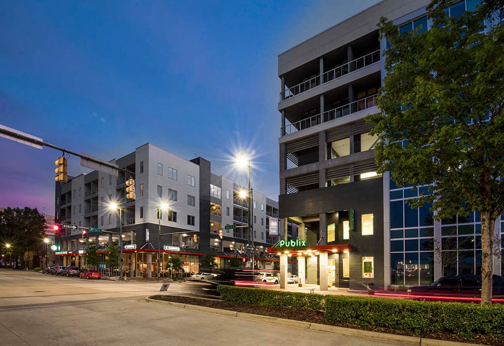 a city street at night with buildings and street lights