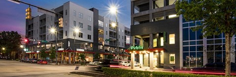 a city street at night with tall buildings