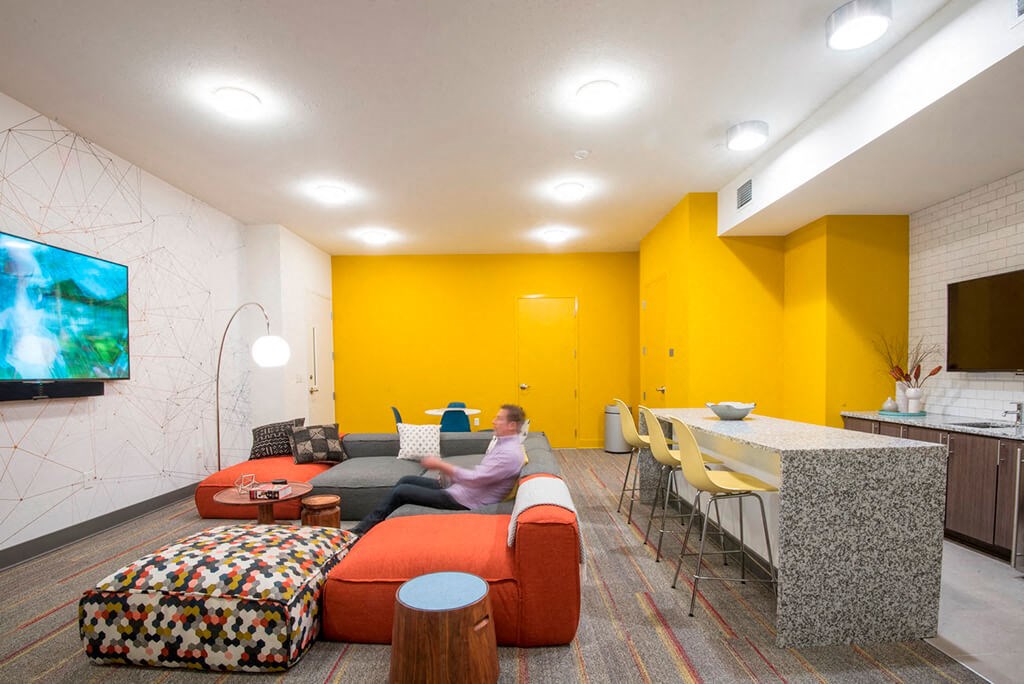 a man sitting on a couch in a living room