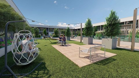 a group of people sitting on a swing in a park
