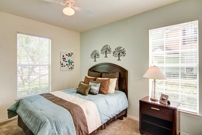 primary bedroom with walk in closet at Legacy at Crystal Lake Apartments in Port Orange, Florida Primary bedroom with large windows and walk in closet at Legacy at Crystal Lake Apartments in Port Orange, Florida - Photo Gallery