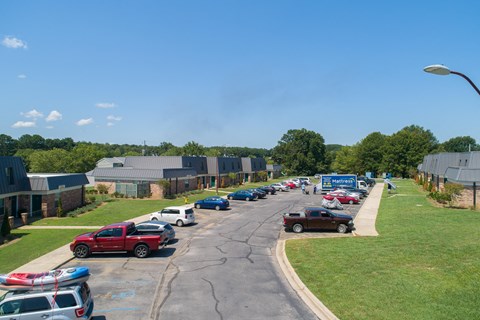 a parking lot filled with cars and buildings