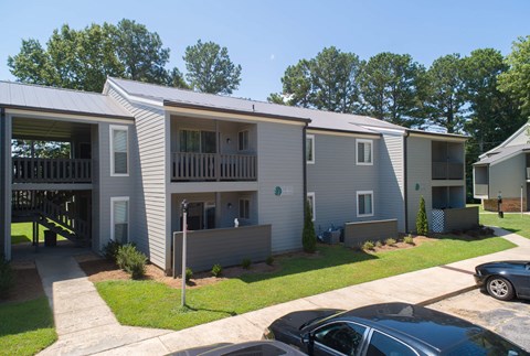 an apartment building with cars parked in front of it