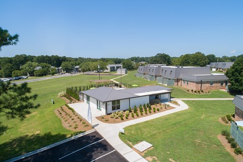 an aerial view of a group of houses in a field