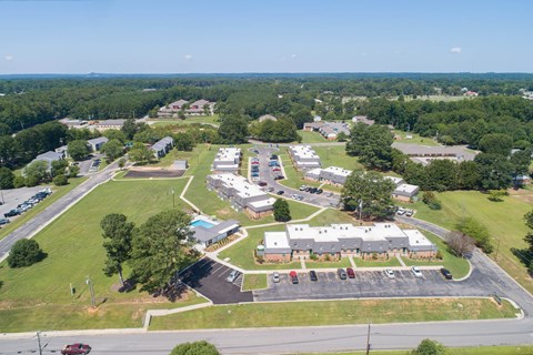 an aerial view of a city with houses and a parking lot