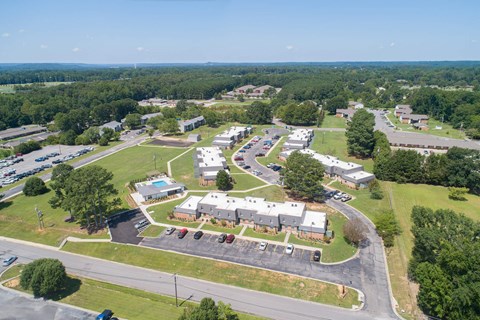 an aerial view of a city with houses and parking lot