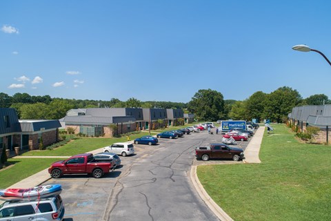 a parking lot filled with cars and buildings