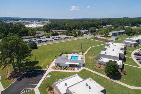 an aerial view of a neighborhood with buildings and a swimming pool