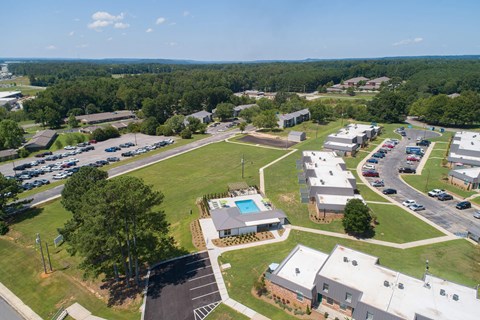 an aerial view of a neighborhood of buildings and a parking lot
