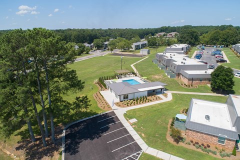 an aerial view of the campus with buildings and a parking lot