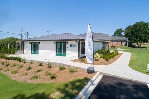 a small white house with a flag in front of it