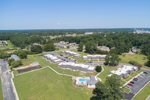 a aerial view of a neighborhood of houses and a field