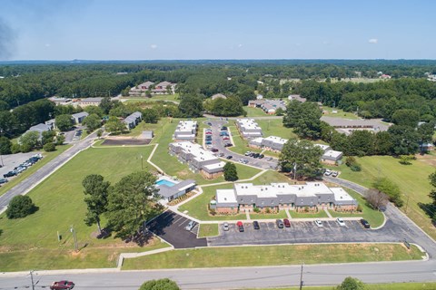an aerial view of a city with houses and a parking lot