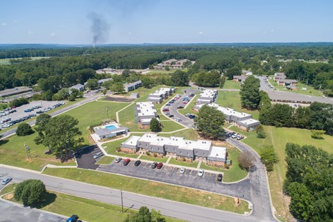 an aerial view of a city with buildings and a parking lot