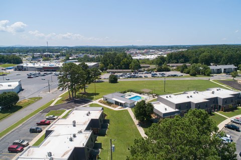 an aerial view of a parking lot and buildings in a city