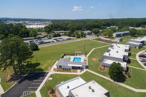 an aerial view of a neighborhood with buildings and a swimming pool