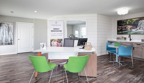 a break room with green chairs and a white table