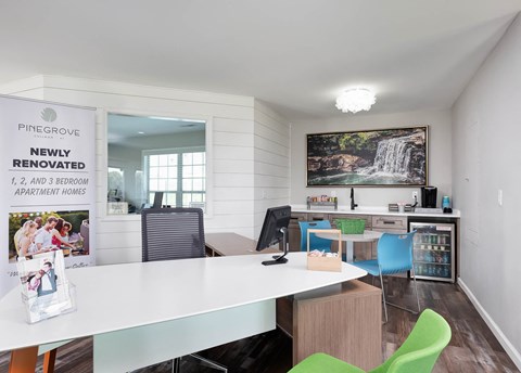 an office with a white table and chairs and a bulletin board