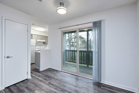 a living room with a sliding glass door to a balcony