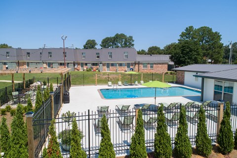 our apartments have a pool and a patio with chairs