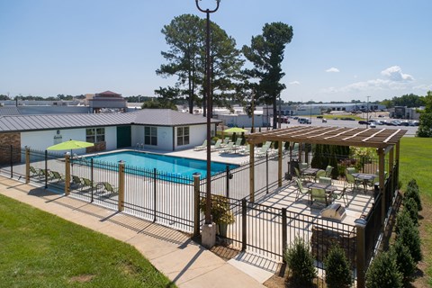 our apartments have a large pool and a patio with chairs