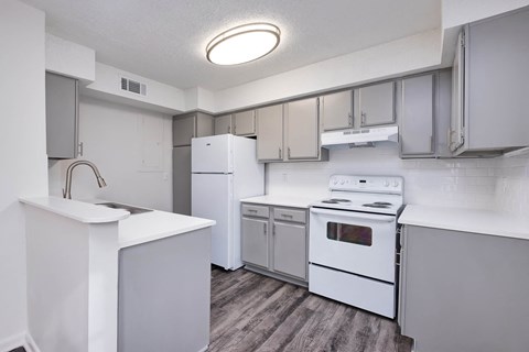 a white kitchen with white appliances and white cabinets