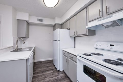 a white kitchen with white appliances and white cabinets
