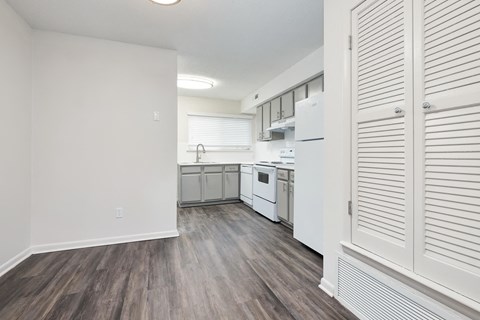a renovated kitchen with white appliances and white cabinets