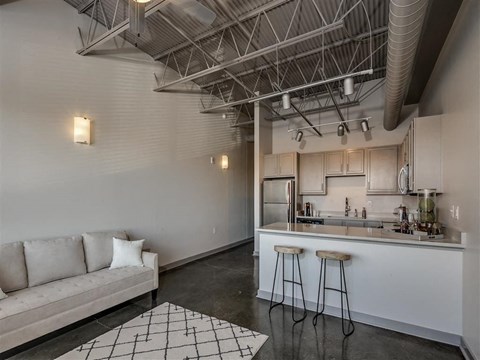 a living room with a kitchen and a couch