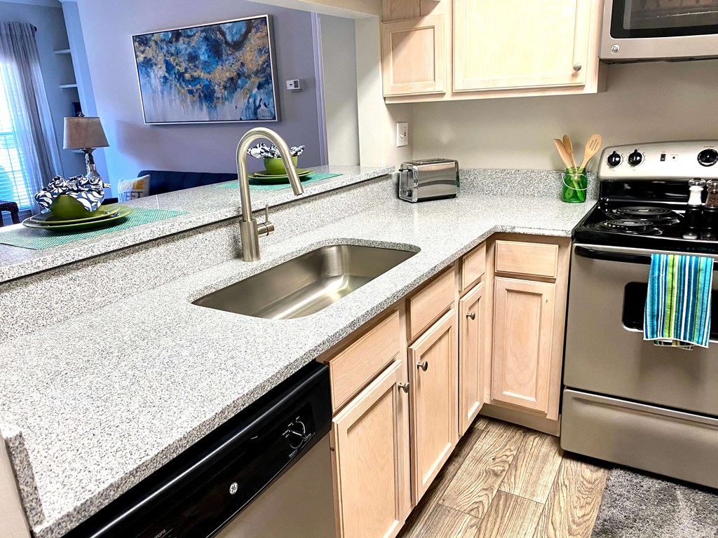 Quartz countertops and stainless steel appliances at Village at Caldwell Mill Apartments in Birmingham, Alabama