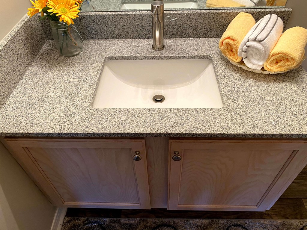 updated bathrooms with wood floors at Village at Caldwell Mill Apartments in Birmingham, Alabama