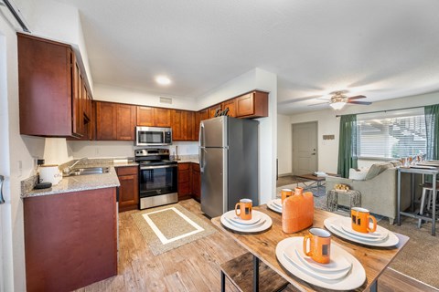 a kitchen with stainless steel appliances and a dining table