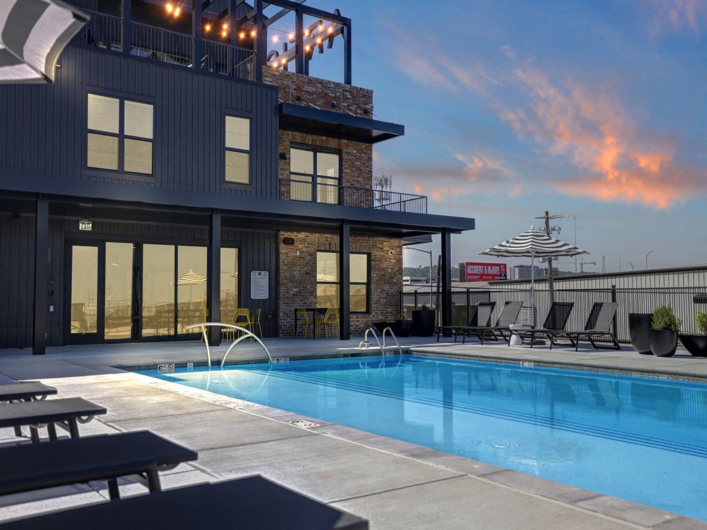 Twilight Pool View with Soft Seating at Artisan Flats Apartments in Birmingham, AL
